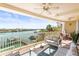 Spacious waterfront balcony furnished with comfortable seating, ceiling fans, and stunning water views at 3805 Gulf Blvd # 404, St Pete Beach, FL 33706