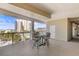 Spacious balcony with a table and chairs overlooking the ocean and beachfront buildings at 3805 Gulf Blvd # 404, St Pete Beach, FL 33706