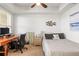 Cozy bedroom with a desk and chair, a full bed, and a window providing natural light at 3805 Gulf Blvd # 404, St Pete Beach, FL 33706
