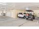 Spacious and well-lit garage offering ample parking space, featuring a golf cart and car at 3805 Gulf Blvd # 404, St Pete Beach, FL 33706