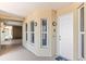 Condo hallway featuring decorative nautical-themed sconces and white entry door at 3805 Gulf Blvd # 404, St Pete Beach, FL 33706