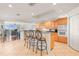 Open kitchen with breakfast bar and view to the living space and balcony at 3805 Gulf Blvd # 404, St Pete Beach, FL 33706