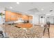 Open kitchen with granite countertops, breakfast bar, and wooden cabinets at 3805 Gulf Blvd # 404, St Pete Beach, FL 33706