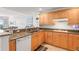 Modern kitchen with wooden cabinets, granite countertops, and stainless steel appliances at 3805 Gulf Blvd # 404, St Pete Beach, FL 33706