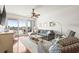 Bright living room with a ceiling fan, a sliding glass door, and comfortable seating at 3805 Gulf Blvd # 404, St Pete Beach, FL 33706
