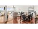 Open concept living room with wood floors, dining area and sliding glass door to balcony at 3805 Gulf Blvd # 404, St Pete Beach, FL 33706