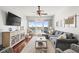 Well-lit living room with comfortable seating, a ceiling fan, and balcony access at 3805 Gulf Blvd # 404, St Pete Beach, FL 33706