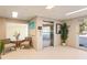 Bright condo lobby with elevator, seating area, beach painting, and indoor plants at 3805 Gulf Blvd # 404, St Pete Beach, FL 33706