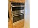 Modern stainless steel oven and microwave combo built into light wood cabinetry in the kitchen at 3805 Gulf Blvd # 404, St Pete Beach, FL 33706