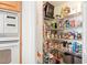 Walk-in pantry with wire shelving stocked with food items and household goods at 3805 Gulf Blvd # 404, St Pete Beach, FL 33706