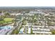 A high-angle view of a well-planned community with pools, mature trees, and recreation areas at 504 Cara Ct # 504, Largo, FL 33771