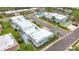 This angle shows the community featuring a pool, shuffleboard, assigned parking and mature landscaping at 504 Cara Ct # 504, Largo, FL 33771
