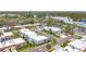 Aerial view of a quiet community with single-story homes, mature trees, community pool, and assigned parking at 504 Cara Ct # 504, Largo, FL 33771