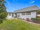 Charming home featuring a neatly landscaped backyard and a screened-in porch at 504 Cara Ct # 504, Largo, FL 33771