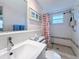 Bright bathroom featuring a unique patterned shower curtain and a functional hand-held shower head at 504 Cara Ct # 504, Largo, FL 33771