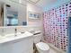 Bright bathroom with a modern vanity, shower-tub combo, and neutral tile at 504 Cara Ct # 504, Largo, FL 33771