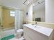Bright bathroom with shower-tub combo, white vanity, and updated fixtures at 504 Cara Ct # 504, Largo, FL 33771