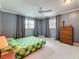 Spacious bedroom featuring neutral walls, carpet, ceiling fan, and a large dresser at 504 Cara Ct # 504, Largo, FL 33771