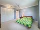 Comfortable bedroom with a ceiling fan, carpet floors, and large closet for storage at 504 Cara Ct # 504, Largo, FL 33771