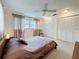Comfortable bedroom with plush carpet, ceiling fan, and double closets at 504 Cara Ct # 504, Largo, FL 33771