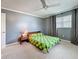 Cozy bedroom with gray walls, soft carpet, natural light, and a ceiling fan at 504 Cara Ct # 504, Largo, FL 33771
