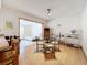 Open dining area with wood floors, a glass table, and an adjacent room with a bed at 504 Cara Ct # 504, Largo, FL 33771