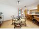 Dining area with a glass table, open concept to the kitchen, and neutral walls at 504 Cara Ct # 504, Largo, FL 33771