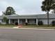 Well-maintained community building surrounded by lush landscaping and palm trees at 504 Cara Ct # 504, Largo, FL 33771