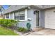 Well-maintained home featuring a textured exterior, tidy front yard and updated front door at 504 Cara Ct # 504, Largo, FL 33771