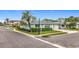 Corner lot featuring tidy landscaping and multiple palm trees, near crosswalk at 504 Cara Ct # 504, Largo, FL 33771