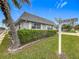 Corner lot with tidy landscaping, including a mature palm tree and a street sign at 504 Cara Ct # 504, Largo, FL 33771