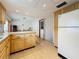 Functional kitchen featuring wooden cabinets, white appliances, and laminate floors at 504 Cara Ct # 504, Largo, FL 33771