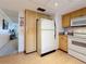 Efficient kitchen featuring wooden cabinets, a white refrigerator, and laminate floors at 504 Cara Ct # 504, Largo, FL 33771