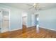 Bedroom showcasing wood-look floors, two closets, and a ceiling fan with an attached bathroom at 5111 Dahlia N St, Pinellas Park, FL 33782