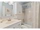 Clean bathroom featuring a shower and bath, vanity and sink with white cabinets and drawers at 5267 81St N St # 18, St Petersburg, FL 33709