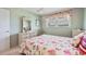 Bright bedroom with floral accents, including window treatments and a comfortable bed at 5267 81St N St # 18, St Petersburg, FL 33709