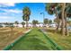 Community bocce ball court with palm trees and condo buildings in background at 5267 81St N St # 18, St Petersburg, FL 33709