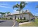 Exterior view of a well-maintained community building with neatly trimmed bushes and a paved walkway at 5267 81St N St # 18, St Petersburg, FL 33709