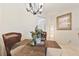 Charming dining area with a round glass table, wicker chairs, and a view into the living area at 5267 81St N St # 18, St Petersburg, FL 33709