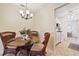 Cozy dining area featuring a round glass table with wicker chairs and view into kitchen at 5267 81St N St # 18, St Petersburg, FL 33709