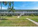 Exterior shot showing a 2-story condo building with palm trees and well-manicured lawns at 5267 81St N St # 18, St Petersburg, FL 33709