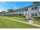 Two-story condo building featuring well-manicured landscaping and exterior staircases at 5267 81St N St # 18, St Petersburg, FL 33709