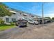 Well-maintained condo building featuring covered parking, manicured landscaping, and awning-covered windows at 5267 81St N St # 18, St Petersburg, FL 33709