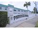 Exterior view of Paradise Shores building with community sign, palm tree, and clean landscaping at 5267 81St N St # 18, St Petersburg, FL 33709