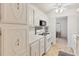 This cozy kitchen features white appliances, cabinetry with unique hardware, and neutral tile flooring at 5267 81St N St # 18, St Petersburg, FL 33709