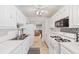 A clean, well-lit kitchen offering ample storage, modern appliances, and a seamless flow to living spaces at 5267 81St N St # 18, St Petersburg, FL 33709