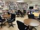 Cozy community library with shelves filled with books and tables for reading at 5267 81St N St # 18, St Petersburg, FL 33709