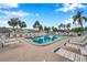Relaxing community pool featuring lounge chairs, palm trees, and tiki huts at 5267 81St N St # 18, St Petersburg, FL 33709