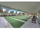Community shuffleboard court under a covered pavilion with benches for spectators at 5267 81St N St # 18, St Petersburg, FL 33709