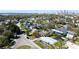 A lovely neighborhood with tree-lined streets and attractive homes is captured in this aerial view against a city backdrop at 531 Luzon Ave, Tampa, FL 33606